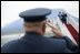 President George W. Bush returns a salute from Brigadier General David S. Gray, Commander, 89th Airlift Wing as he and Mrs Bush board Air Force One before departing Andrews Air Force Base for Latvia, Friday, May 6, 2005.