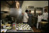 Mrs. Laura Bush tours the new kitchen at Willie Mae’s Scotch House Thursday, April 19, 2007, in New Orleans, La. The restaurant was destroyed in Hurricane Katrina. Pictured with Mrs. Bush are, from left, Willie Mae’s grandson Ronnie Seaton, Sr., 93-year-old Willie Mae Seaton, and Chef John Besh of Restaurant August.