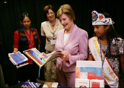 Mrs. Laura Bush looks over reading materials on display Friday, Aug. 3, 2007, at the various information and educational booths of the Saint Paul Community Partnerships Serving American Indian Youth at the Helping AmericaÕs Youth Fourth Regional Conference in St. Paul, Minn. White House photo by Chris Greenberg