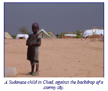 A Sudanese child in Chad against the backdrop of a stormy sky.