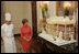 Laura Bush is shown the White House gingerbread house by White House pastry chef Thaddeus DuBois, on display in the State Dining Room.