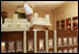 Thaddeus DuBois, Head Pastry Chef, places the roof on top of the White House gingerbread house.