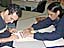 Wanda Diaz helps a student read a book that is written in Braille