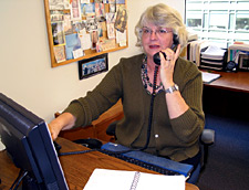 Image of Anne, talking on phone at work