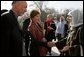 First lady Laura Bush and Margaret Spellings, Secretary of Education, center, stand with Afghan President Hamid Karzai Wednesday, March 30, 2005, after their arrival in Kabul. White House photo by Susan Sterner