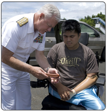 Navy Adm. Timothy J. Keating, commander of U.S. Pacific Command, presents a pen set as a token of appreciation to Hilario Bermanis II, during the admiral’s visit to Micronesia April 8, 2008. Bermanis, a Micronesian, lost two legs and an arm while serving with the U.S. 82nd Airborne Division in Iraq.