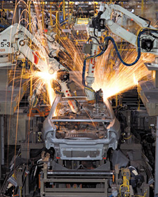 Image of a car being built on an assembly line