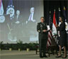 Secretary Rice presents General David Patraeus and Ambassador to Iraq Ryan Crocker, seen on video screen in left background, the Secretarys Distinguished Service Award [AP Image Oct. 6, 2008]