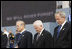 President George W. Bush is joined by former Secretary of Defense Donald Rumsfeld, left, and U.S. Secretary of Defense Robert Gates, as they bow their heads during a moment of silence Thursday, Sept. 11, 2008, during the dedication of the 9/11 Pentagon Memorial at the Pentagon in Arlington, Va.