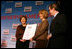 Mrs. Laura Bush presents fifth grade history teacher Maureen Festi, center, who teaches at Stafford Elementary School in Stafford, Conn., with the 2007 Preserve America National History Teacher of the Year Award at the Museum of the City of New York, Friday, Nov.16, 2007 in New York. Dr. James Basker, president of the Gilder Lehrman Institute for American History.