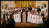 President George W. Bush and Mrs. Laura Bush join singer Melinda Doolittle, center, and members of the World Children's Choir on stage Tuesday evening, Nov. 13, 2007in the East Room of the White House, during the social dinner in honor of the tenth anniversary of America's Promise-The Alliance for Youth.