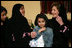 Mrs. Laura Bush talks with Dr. Samia Al-Amoudi, a breast cancer survivor, during a "Breaking the Silence" Coffee Wednesday, Oct. 24, 2007, in Jeddah, Saudi Arabia. Mrs. Bush met with breast cancer survivors and members of their families to discuss awareness issues. Pictured at left is Dr. Samia's daughter, Esraa Al-Harbi, 10-year-old author of a children's book entitled, "My Mother and Breast Cancer." The child at center is unidentified.