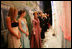 Laura Bush shares a private moment with her twin daughters Jenna, left, and Barbara before walking on stage for the Texas State Society's Black Tie and Boots Inaugural Ball in Washington, D.C., Wednesday, Jan. 19, 2005. Also pictured are, from left, President George W. Bush, Texas Congresswoman Kay Granger, Vice President Dick Cheney, Lynne Cheney, Texas Sen. John Cornyn, and Texas Gov. Rick Perry.