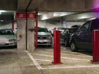 (Fig. 4.9) Bollards and striping to create an access path in a parking garage.  Bright signs at the top of column help to locate the valve.