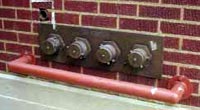 (Fig. 5.3) A 4-inlet FDC.  It would probably be more efficient, and give the fire department more options, to have placed two, 2-inlet FDCs in different locations on this building.