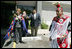 Laura Bush wears a traditional Native American wrap as she watches a musical performance before touring the Native American Community Health Center in Phoenix, Ariz., April 26, 2005.