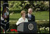 President George W. Bush looks on as he's introduced by First Lady Laura Bush Wednesday, April 20, 2005, to honor the 2005 National Teacher of the Year during ceremonies in the Rose Garden. Jason Kamras, a math teacher of eight years at John Philip Sousa Middle School in Washington, D.C., received the honors.