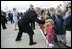 Greeted by flowers and smiles, President George W. Bush returns the gesture during his and Laura Bush's arrival in Maastricht, Netherlands, May 7, 2005.