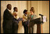 Mrs. Laura Bush is joined on stage by Ballou High School Marching Band Director Darrell Watson, left, as she greets band members Lewis Franklin, Rhia Hardman and Kenneth Horne, right, at the White House Thursday, Oct. 11, 2007, prior to a screening of Ballou: A Documentary Film, about the Washington, D.C. band’s inspiring accomplishments for the students and their school.