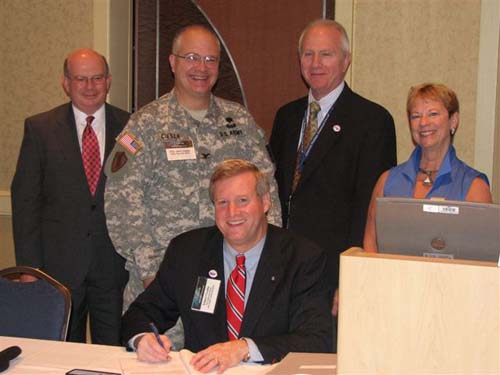 Edwin G. Foulke, Jr., Assistant Secretary of Labor, OSHA (Seated) and standing from left to right; Jerry Aslinger, Director of Department of Defense Mishap Reduction Programs, Colonel John Ciesla, Office of Assistant Secretary of the Army, Installations & Environment, Steven Witt, Director of the Directorate of Cooperative and State Programs (OSHA) Cathy Oliver, Director of Office of Partnerships and Recognition (OSHA), sign a partnership agreement between the Army and Occupational Safety and Health Administration on August 25, 2008 in Anaheim, CA at the 24th annual Voluntary Protection Programs Participants' Association Conference