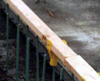 A 2x4 positioned over the top of a row of steel rebar