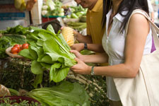 photo of a woman buying lettuce