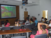 Students wear 3-D glasses to view a GeoWall projection of the sea floor around Puerto Rico