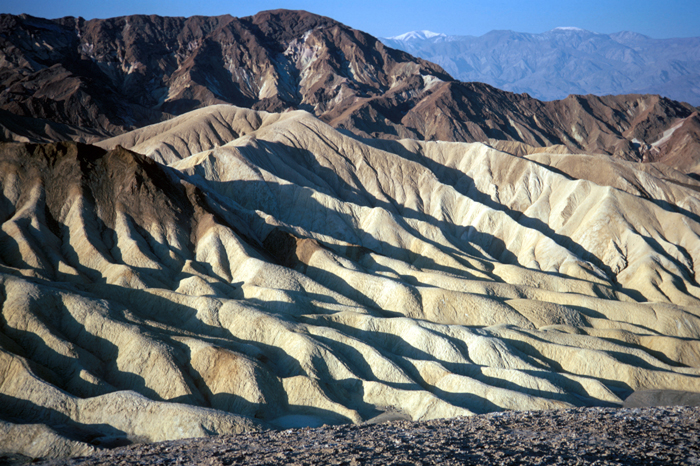 Death Valley National Park, California. Fluted badlands in the area of Zabriskie Point. Panamint Mountains in the background. April 1974.