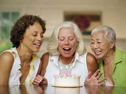 Picture of older women around a birthday cake