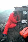 Scientist installing volcano-monitoring equipment on Augustine Volcano, Alaska