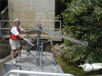 As part of the USGS’s national reconnaissance of the occurrence of emerging contaminants in source waters, scientists collected water samples near intake structures for water-supply plants. Here a USGS technician on a water-quality sampling boat is operating a crane with a water-quality sampler attached -- Duck River, TN