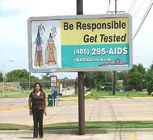 Woman standing under sign - Be responsible Get tested 405-295-AIDS