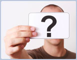 Man Holding Question Mark Card in Front of His Face
