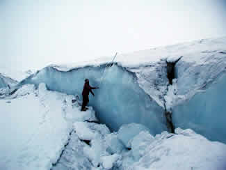 Peter Haeussler prepares to measure the offset of a crevasse on the Canwell Glacier. (U.S. Geological Survey)