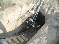 Soil moisture probes and tensiometers installed in the side of a pit for monitoring a tracer test in the unsaturated zone at the Bemidji Crude Oil Spill Research Site, Minnesota. Note black oil-contaminated sand on pit walls.