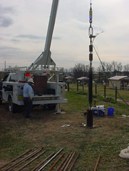 BAT3 suspended over a well at the Lake Wheeler Road Research Site, NC. Steel pipe used to lower the BAT3 into the borehole is visible in the foreground