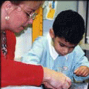 teacher assists a student