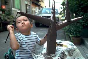 Boy painting a homemade tree in Tokyo, UN/DPI Photo