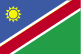 Flag of Namibia is a large blue triangle with a yellow sunburst filling the upper left section and an equal green triangle (solid) filling the lower right section; the triangles are separated by a red stripe that is contrasted by two narrow white-edge borders.