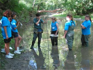 7th and 8th graders learning to stream gage at the Grow Workshop