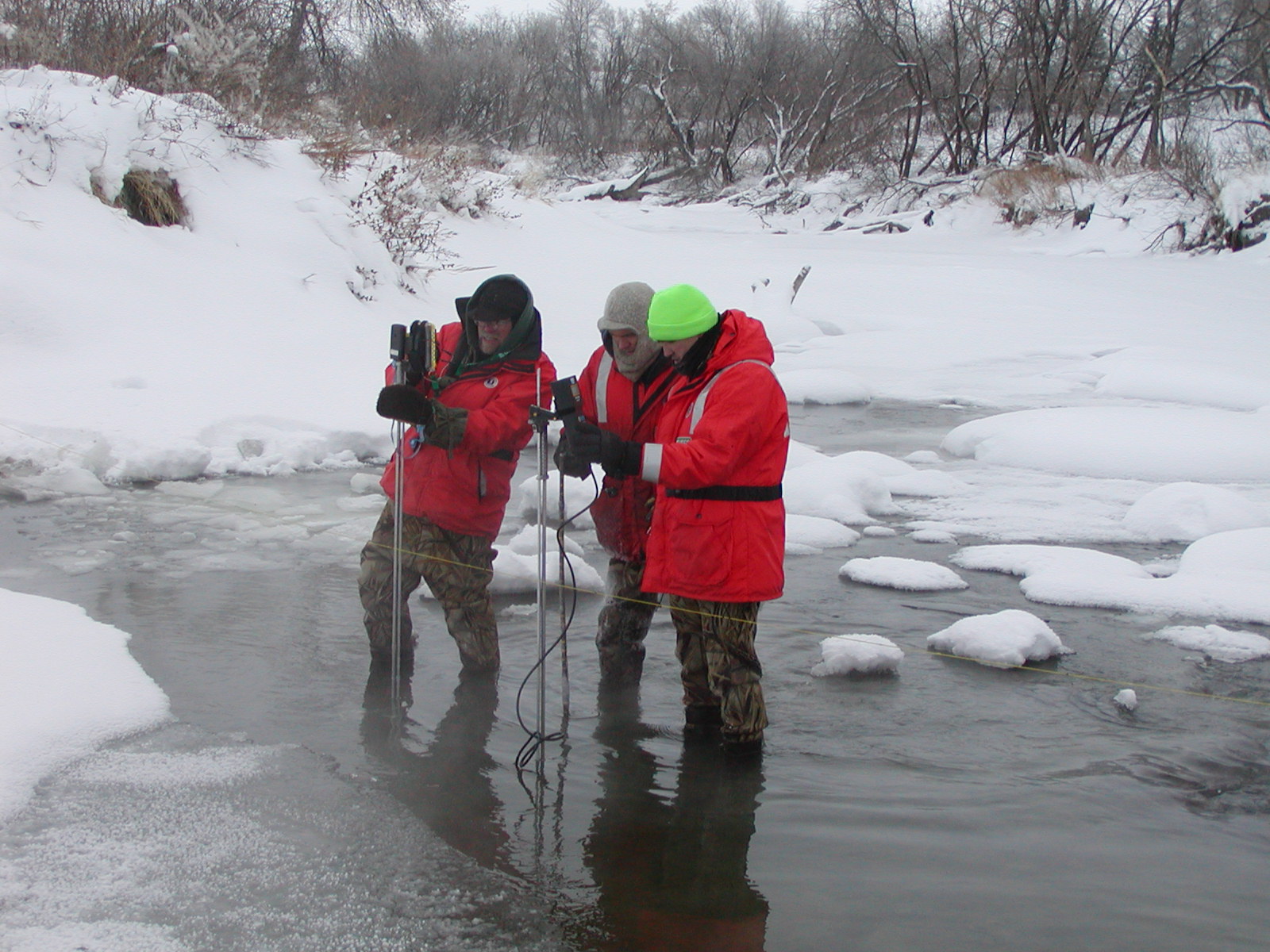 USGS employees at Goose River testing equipment and software in ice conditions