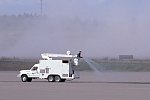 Water is sprayed on ash-covered taxiways and runways, Anchorage International Airport