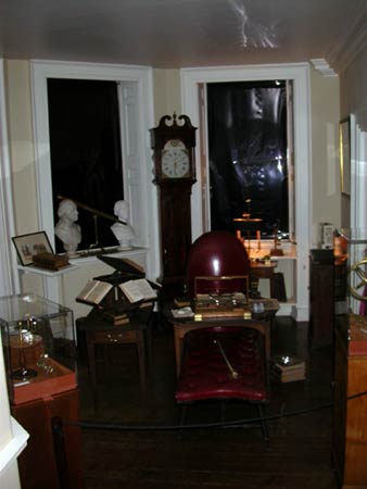 Book room at Monticello with red leather chair, writing table, books and grandfather clock.
