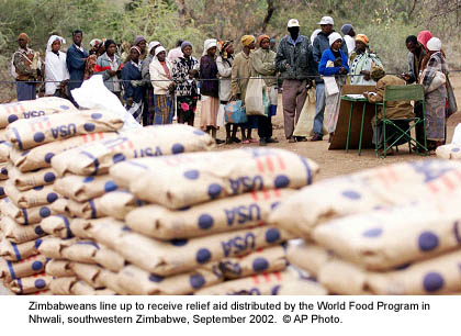 Zimbabweans line up to receive relief aid distributed by the World Food Program in Nhwali, southwestern Zimbabwe, September 2002.