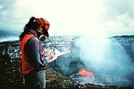 Geologist with gas mask on rim of Pu`u `O`o crater, Kilauea Volcano, Hawai`i
