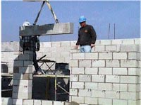 Workers constructing a block masonry wall