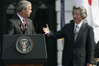 Japanese Prime Minister Junichiro Koizumi reaches out to shake hands with President Bush.