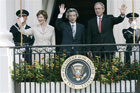 President Bush, first lady Laura Bush and Japanese Prime Minister Junichiro Koizumi wave from the Truman Balcony during an arrival ceremony on the South Lawn of the White House Thursday, June 