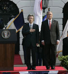 President Bush and Japanese Prime Minister Junichiro Koizumi stand for the national anthem