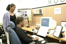 Image of two women working on a computer